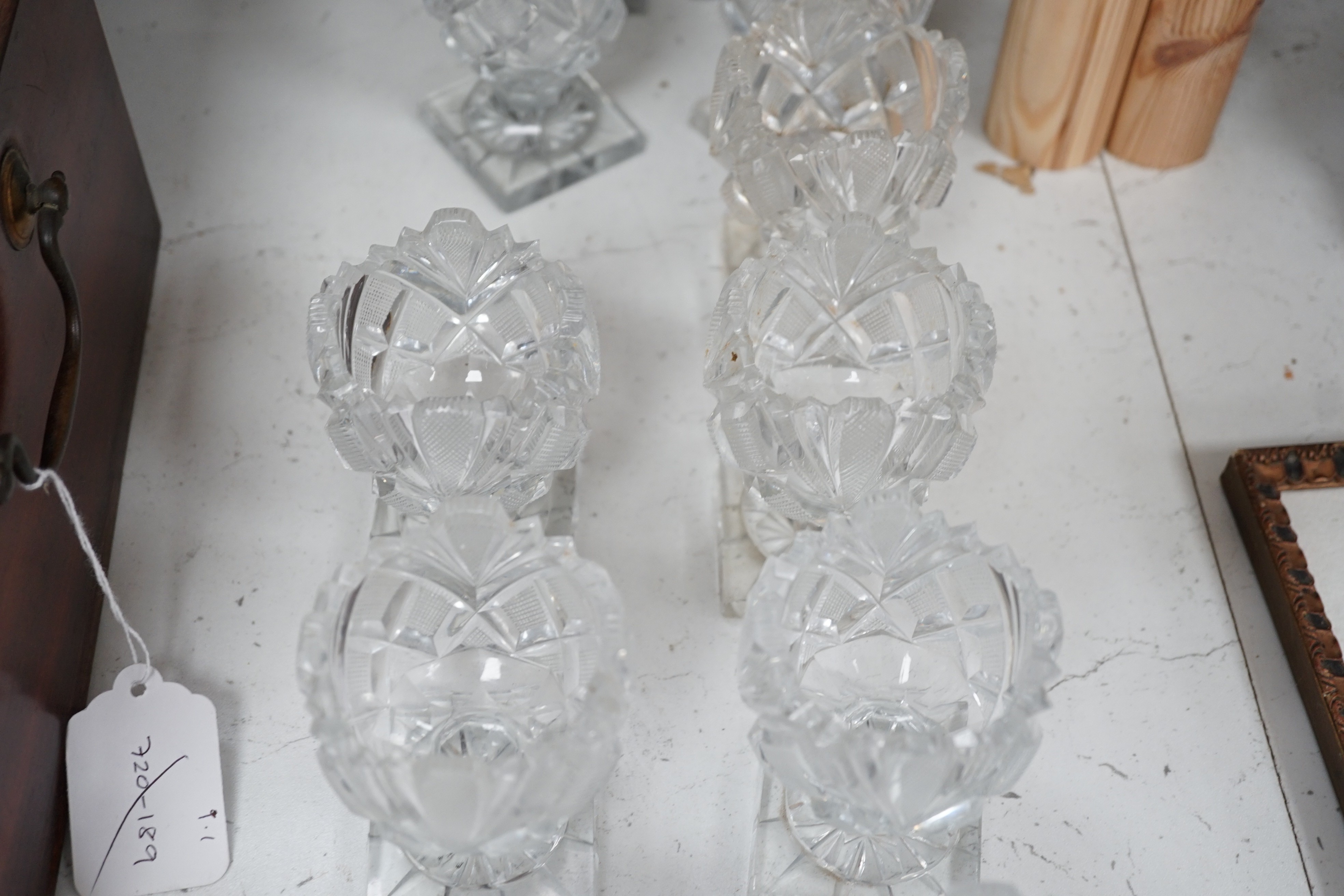 A set of twelve Victorian square base cut glass salts and four other 19th century clear glass salts.